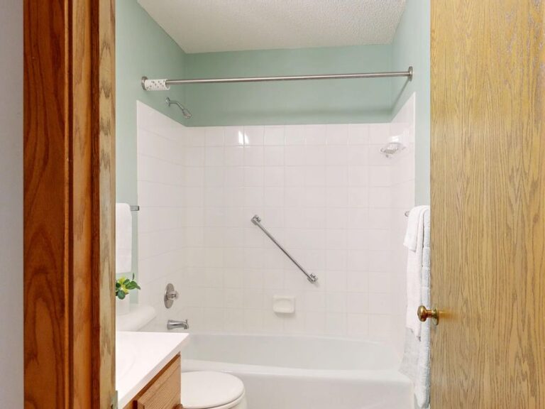 Bathroom safety grab bar installed in bathtub area