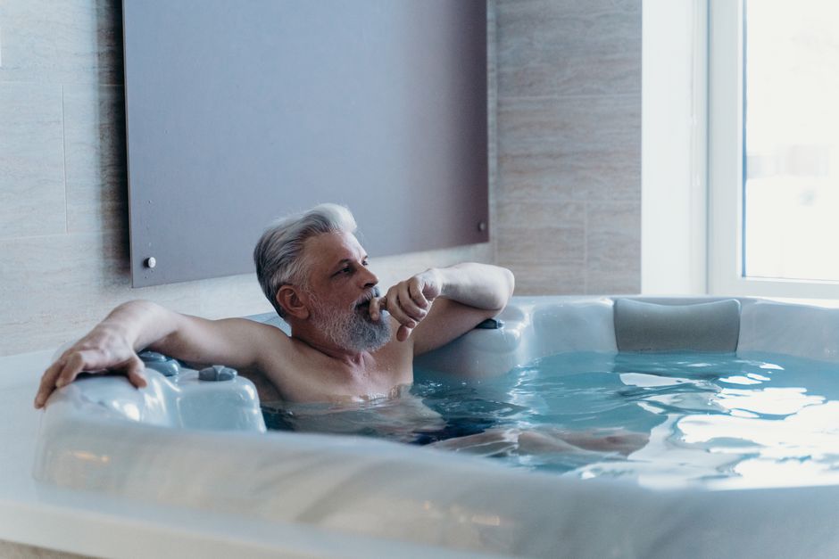 Senior man relaxing in a large accessible bathtub