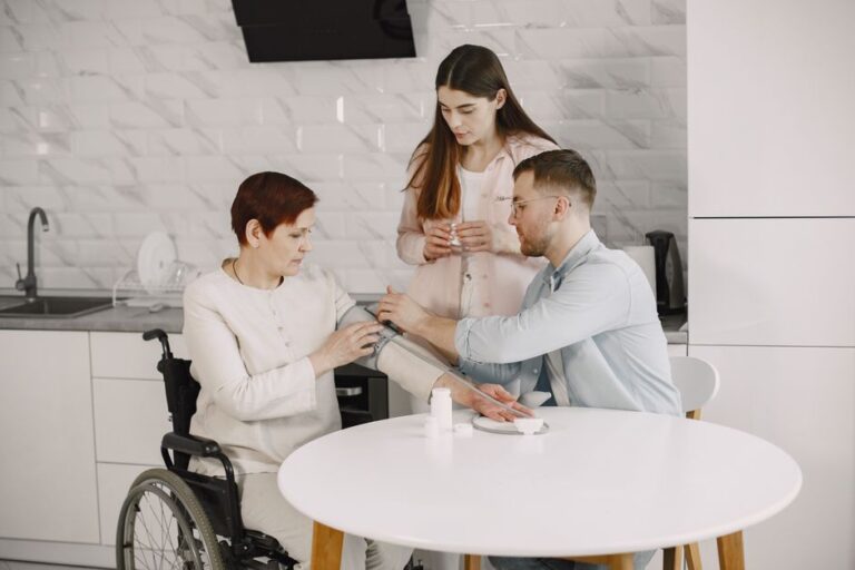 Older woman in wheelchair with family at home